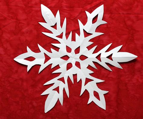 Paper snowflake - Fold one corner of the square across to the other corner to make a paper traingle. Fold the triangle again to make a smaller right triangle. Fold one side of the corner 1/3 of the way in. Repeat on the other side. Flip your folded paper over and …